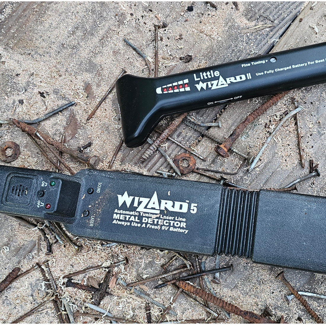 Little Wizard and Wizard 5 woodworking metal detectors surrounded by rusty nails and metal hardware