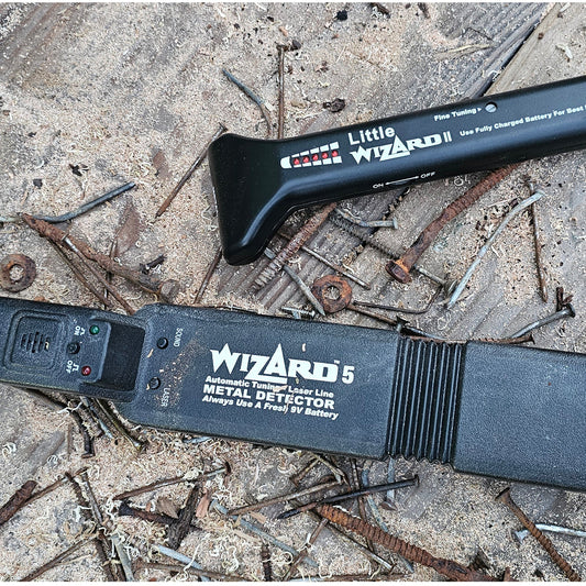 Little Wizard and Wizard 5 woodworking metal detectors surrounded by rusty nails and metal hardware