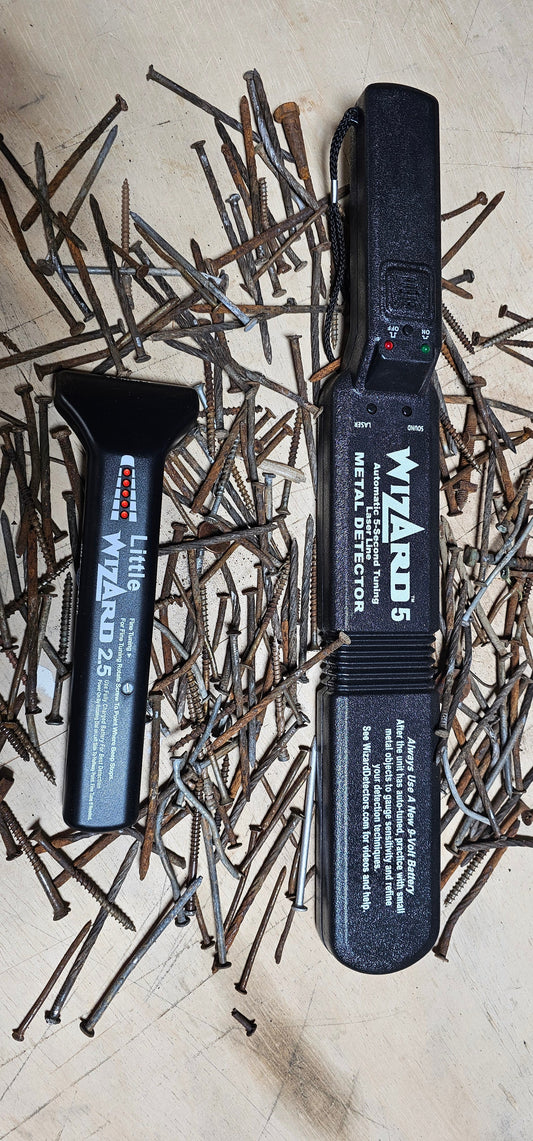 Little Wizard 2.5 and Wizard 5 woodworking metal detectors surrounded by rusty nails and screws